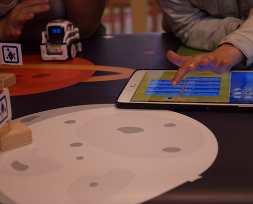 Children selecting story elements on the tablet